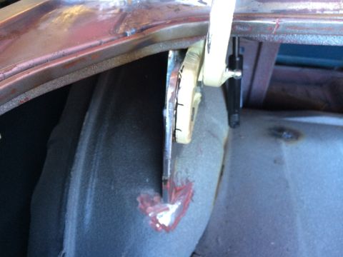 1964 Ford Fairlane - A clamp is used to hold metal in place during repair work in the trunk of a vehicle.