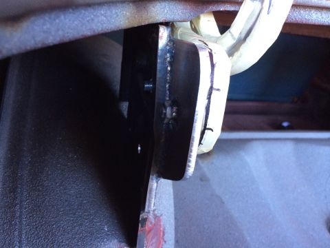 1964 Ford Fairlane - A close-up view of a metal bracket with tape and markings, likely a component within a larger assembly.