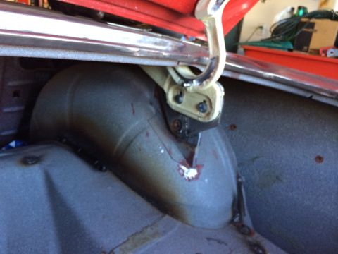 1964 Ford Fairlane - Close-up view of the trunk's latch mechanism and the interior of the wheel well.