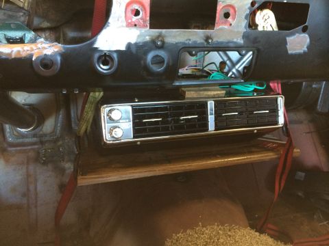 1964 Ford Fairlane - The dashboard of a car is shown with an aftermarket air conditioning unit installed.