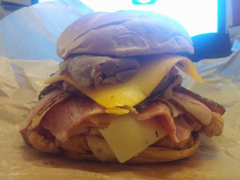 2000 Mercury Grand Marquis - A close-up view of a large sandwich with multiple layers of meat and cheese.