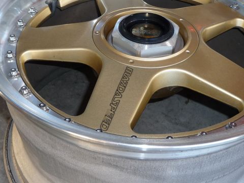 1993 Mazda MX-3 - Close-up of a Mazdaspeed wheel, likely an aftermarket part.