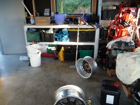 1993 Mazda MX-3 - Garage scene with various car parts and storage shelves visible.
