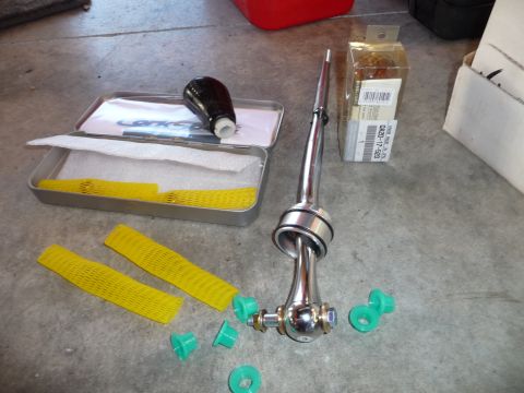 1993 Mazda MX-3 - Short shifter assembly and accessories laid out on a concrete surface.