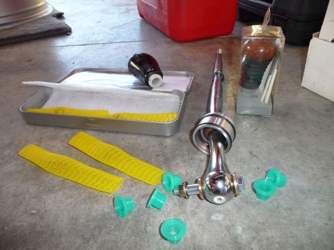 1993 Mazda MX-3 - Short shifter assembly and associated parts laid out on a concrete surface.
