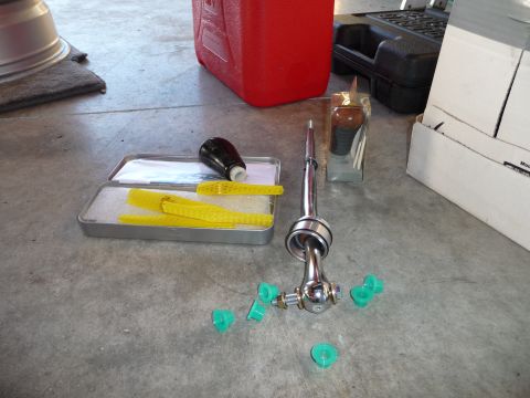 1993 Mazda MX-3 - A collection of car parts, including a short shifter and shift knob, laid out on a concrete floor.