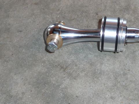 1993 Mazda MX-3 - A polished chrome short shifter assembly, brass and silver accents, rests on a concrete surface.