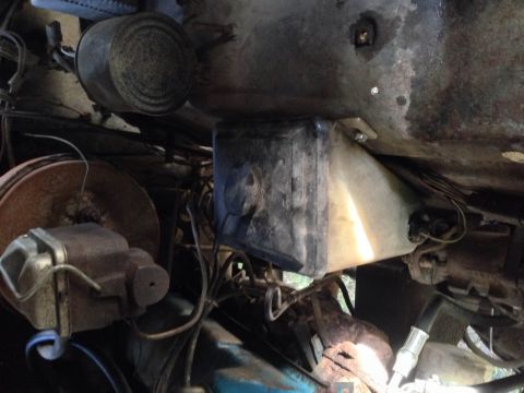1979 Ford Bronco - Underside view of vehicle components, including brake system parts and fluid reservoir.