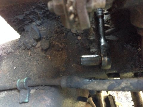 1979 Ford Bronco - A wrench is used on a bolt on the greasy underside of a vehicle, with a Supermotors.net watermark visible.