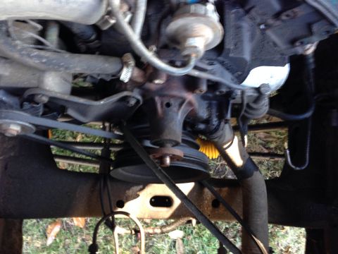 1979 Ford Bronco - Close-up view of engine components including the water pump and drive belts.