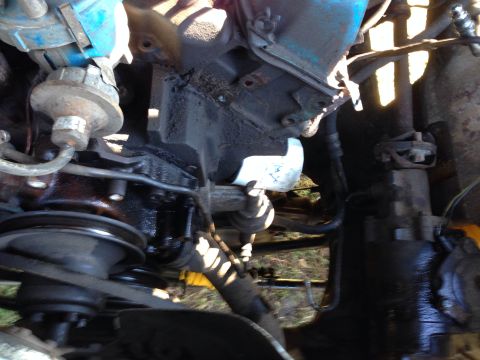 1979 Ford Bronco - Close-up view of a vehicle's engine bay, showing various mechanical components and wiring.