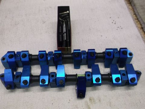 1971 Ford Ranchero - Blue aluminum roller rocker arms and associated hardware laid out on a white surface.