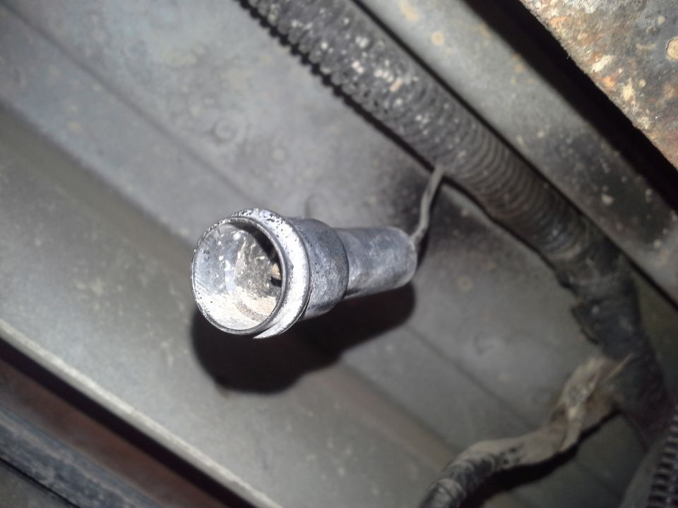 Trailer hitch connector with visible dust and grime, attached to wiring harness