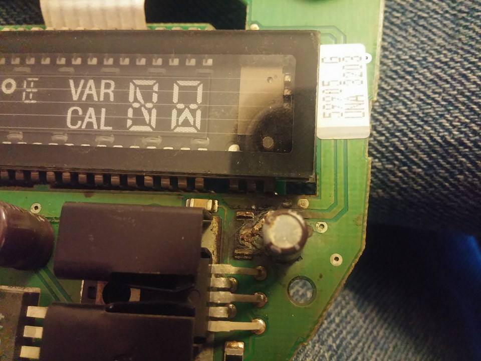 Close-up of a digital display showing 'VAR' and 'CAL' with numbers, on a green circuit board