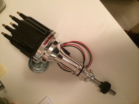 1977 Ford F-350 - A "Flame-Thrower" ignition distributor with visible wiring is shown on a white surface.