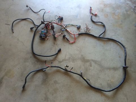 1977 Ford F-350 - This is a vehicle wiring harness, likely for the interior and electrical systems, spread out on a concrete surface.