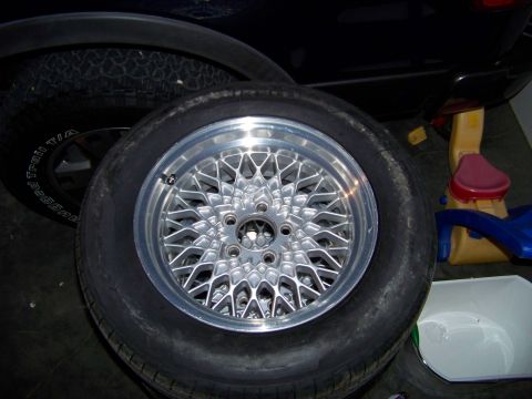 1999 Mercury Grand Marquis - A close-up of an aftermarket wheel and tire, with a portion of a vehicle visible in the background.