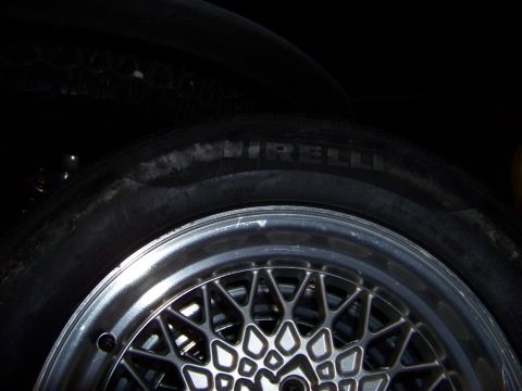 1999 Mercury Grand Marquis - Close-up of a Pirelli tire and a mesh-style alloy wheel.