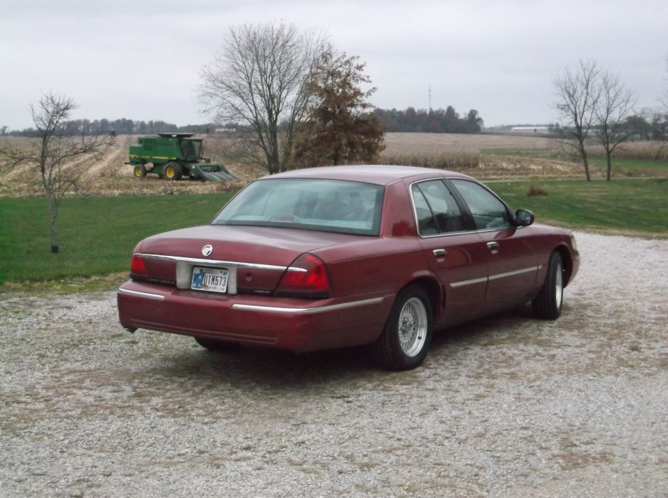 1999 Mercury Grand Marquis rear view, maroon sedan with chrome wheels