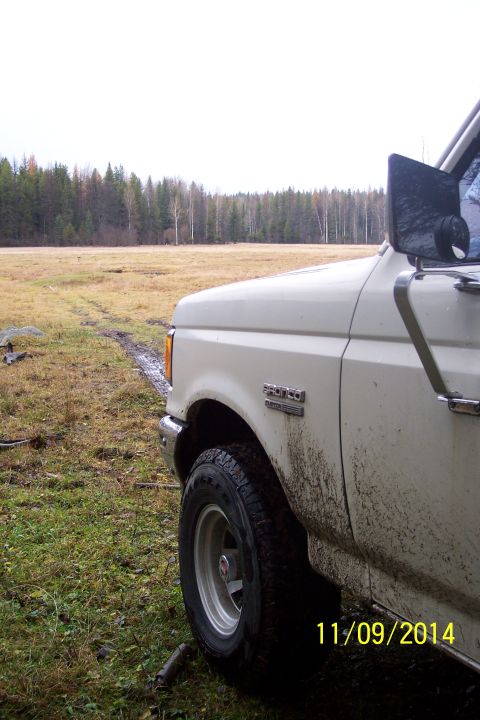 1990 Ford Bronco - Mud-splattered 1990 Ford Bronco in a field on November 9, 2014.