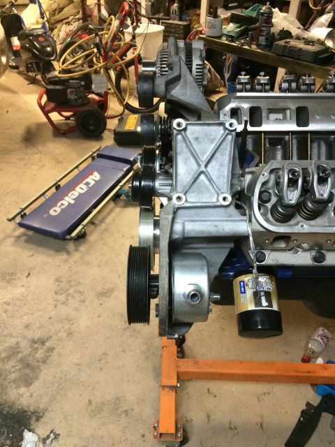 1996 Ford Bronco - A Ford V8 engine is shown on an engine stand, with various tools and equipment in the background.