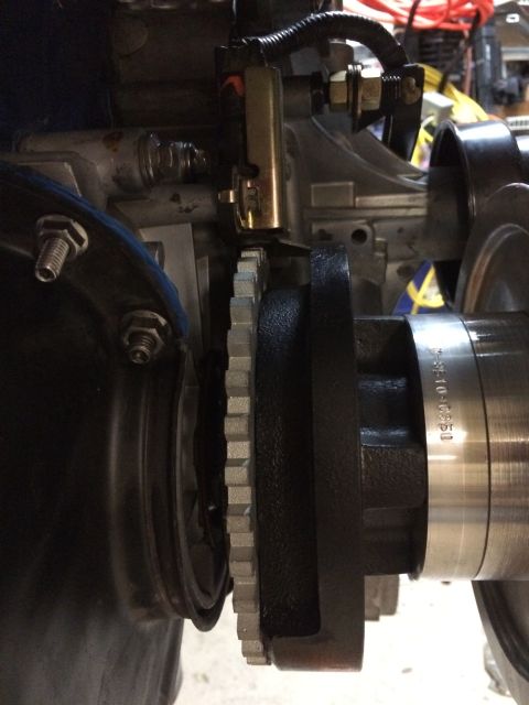 1996 Ford Bronco - A close-up view of engine components, including a toothed gear and a metal housing.