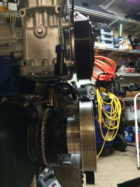 1996 Ford Bronco - Close-up view of an engine's pulley system, multiple belts and associated wiring.