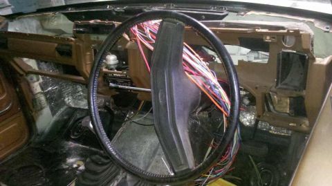 1982 Ford Bronco - Dashboard removed, exposing wiring harness and insulation in a 1982 Ford Bronco interior.