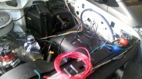 1982 Ford Bronco - Wiring is being installed in the engine bay, showing the heater core and air cleaner assembly.