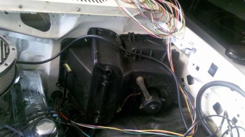 1982 Ford Bronco - The engine bay shows a black HVAC unit and a tangle of wires, with an air filter housing visible on the left.