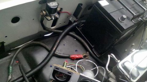 1982 Ford Bronco - Close-up of vehicle battery, starter solenoid, and associated wiring.