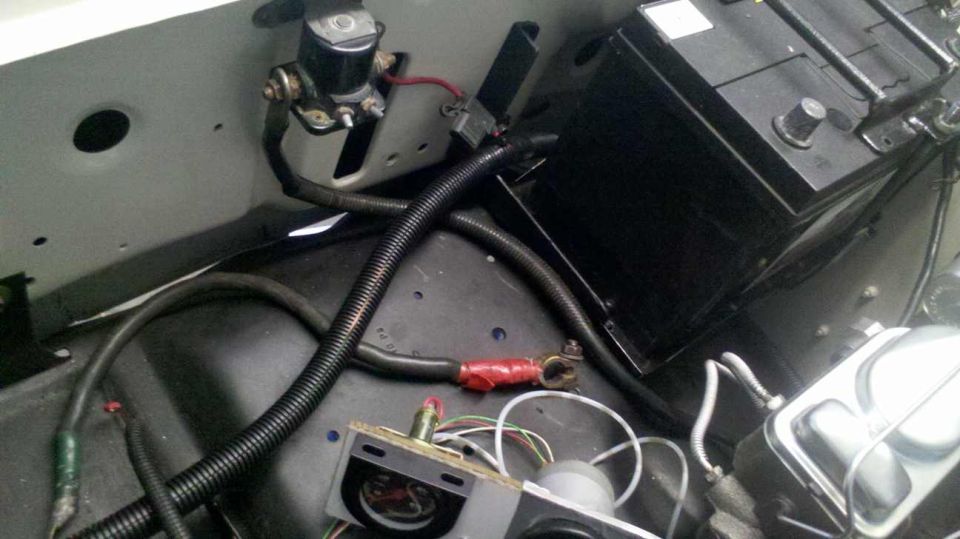 Vehicle battery and starter solenoid with wiring and hoses