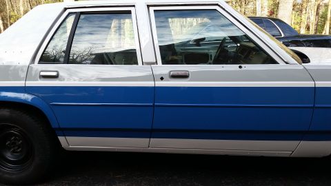 1991 Ford LTD Crown Victoria - This 1991 Ford Crown Victoria LTD features a distinctive two-tone paint scheme with a blue stripe.
