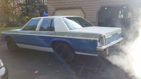 1991 Ford LTD Crown Victoria - 1991 Ford Crown Victoria LTD is seen from the rear, emitting a large cloud of smoke.