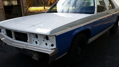 1991 Ford LTD Crown Victoria - This sedan, possibly a Ford Crown Victoria, is undergoing restoration with its front end removed.