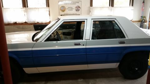 1991 Ford LTD Crown Victoria - This 1991 Ford Crown Victoria LTD is seen from the side, a distinctive blue and white two-tone paint scheme.