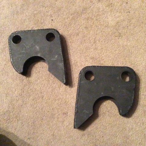 1979 Ford Bronco - Two metal brackets are shown against a carpeted surface. The registry claims they are for a 1979 Ford Bronco.