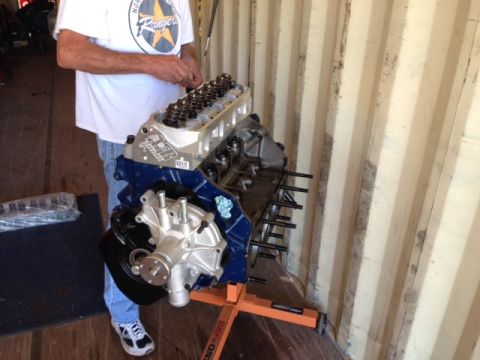 1996 Ford Bronco - Engine assembly is shown with a person standing next to it.