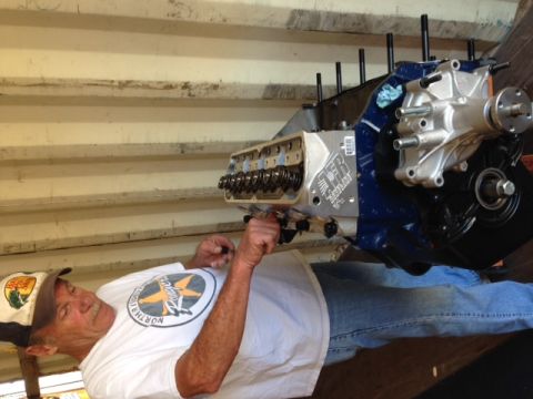 1996 Ford Bronco - Man assembling an engine block, likely for a custom build or restoration project.