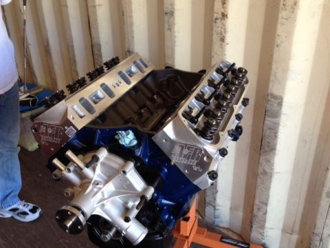 1996 Ford Bronco - A V8 engine is shown, possibly undergoing assembly or modification, with its intake manifold and valve covers exposed.