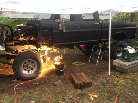 1971 Ford F-250 - This 1971 Ford F-250 crew cab pickup truck is shown in a state of repair, with its engine disassembled and removed from the engine bay.