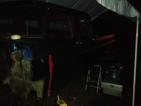 1971 Ford F-250 - Truck bodywork in progress under a tarp at night, with tools and a ladder present.