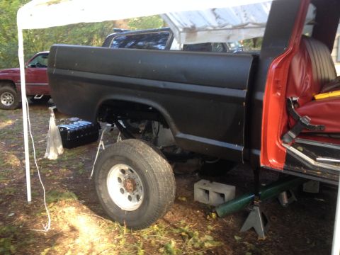 1971 Ford F-250 - Side view of a 1973 Ford F-Series truck undergoing maintenance, with a new fuel tank installed.
