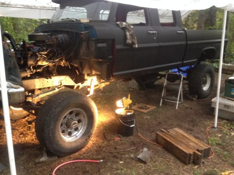 1971 Ford F-250 - This truck is undergoing repairs with its engine compartment exposed and the body painted matte black.