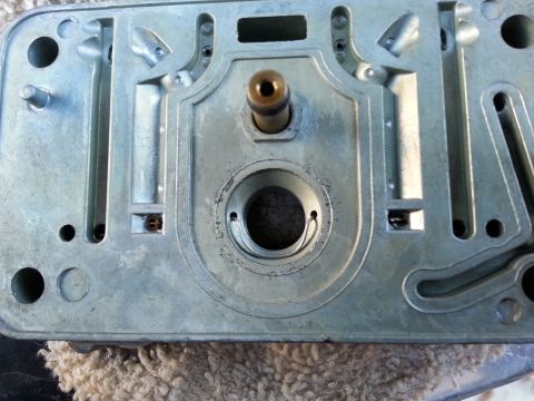 1981 Ford Bronco - This is a close-up view of a carburetor base, showing internal components and mounting holes.