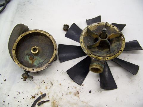 1909 Ford Model T - Disassembled water pump and fan assembly, likely from an older vehicle.