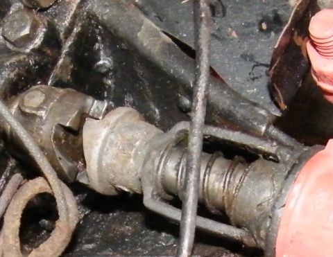 1909 Ford Model T - Mechanical linkage with cables and spring, likely from an engine compartment.