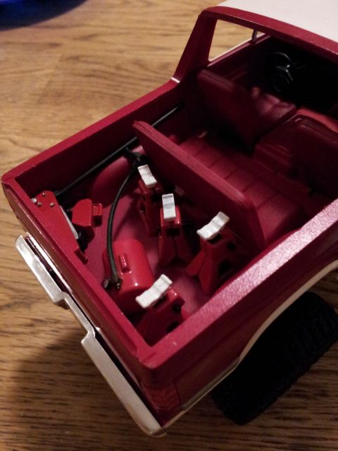 1995 Ford Bronco - A model car's interior is shown with miniature jack stands and other accessories.