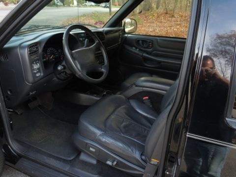 2001 Ford Crown Victoria - Interior view of a black SUV, showing the driver's seat, dashboard, and steering wheel.
