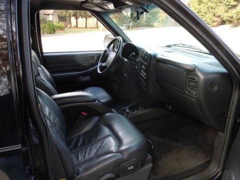2001 Ford Crown Victoria - Interior view of a black SUV, showing the front seats, dashboard, and center console.